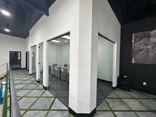 Glass conference room enclosure with full-height partitions by BGM Jacksonville