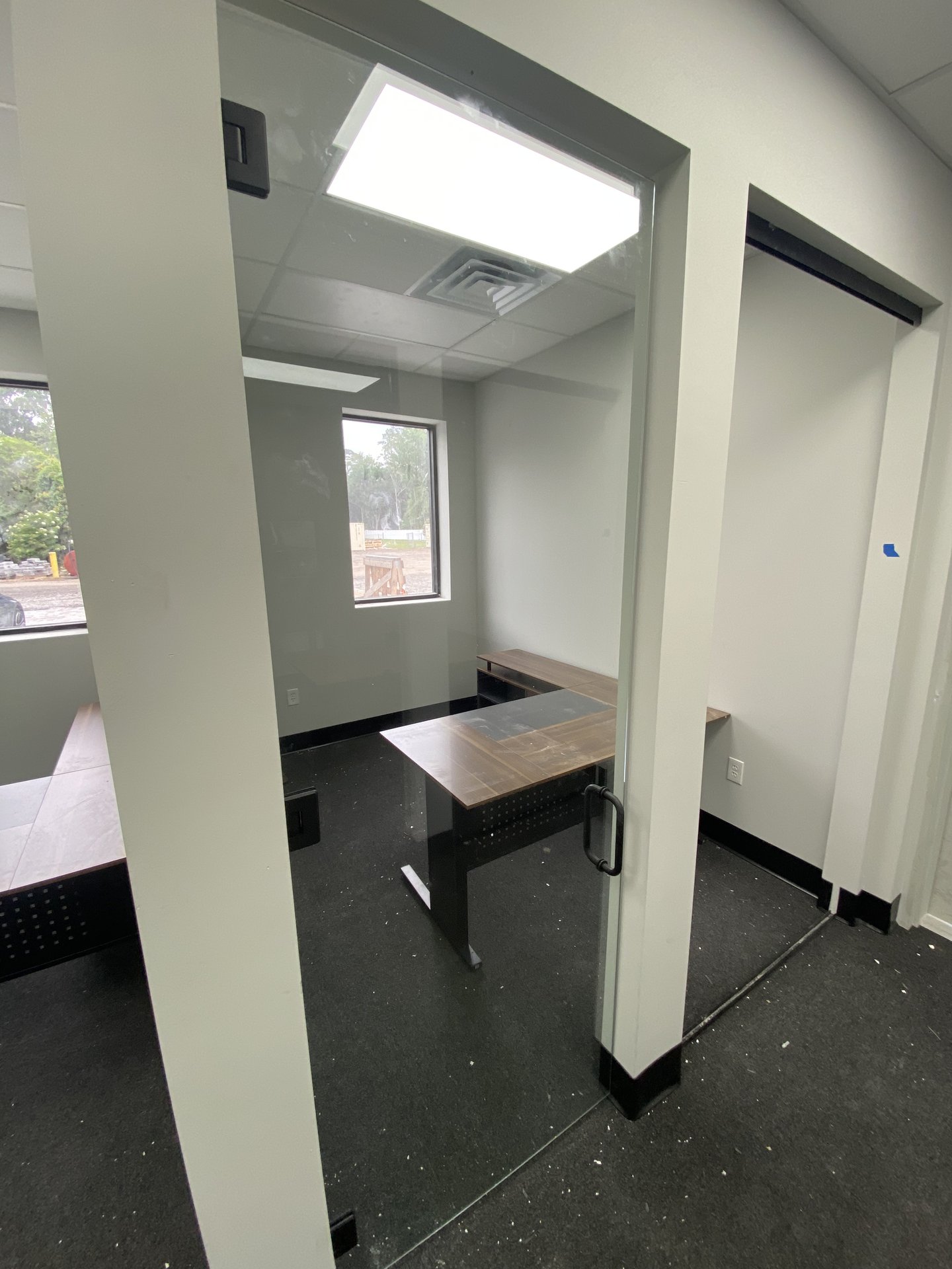 Large-format glass office partition wall installation by BGM Jacksonville